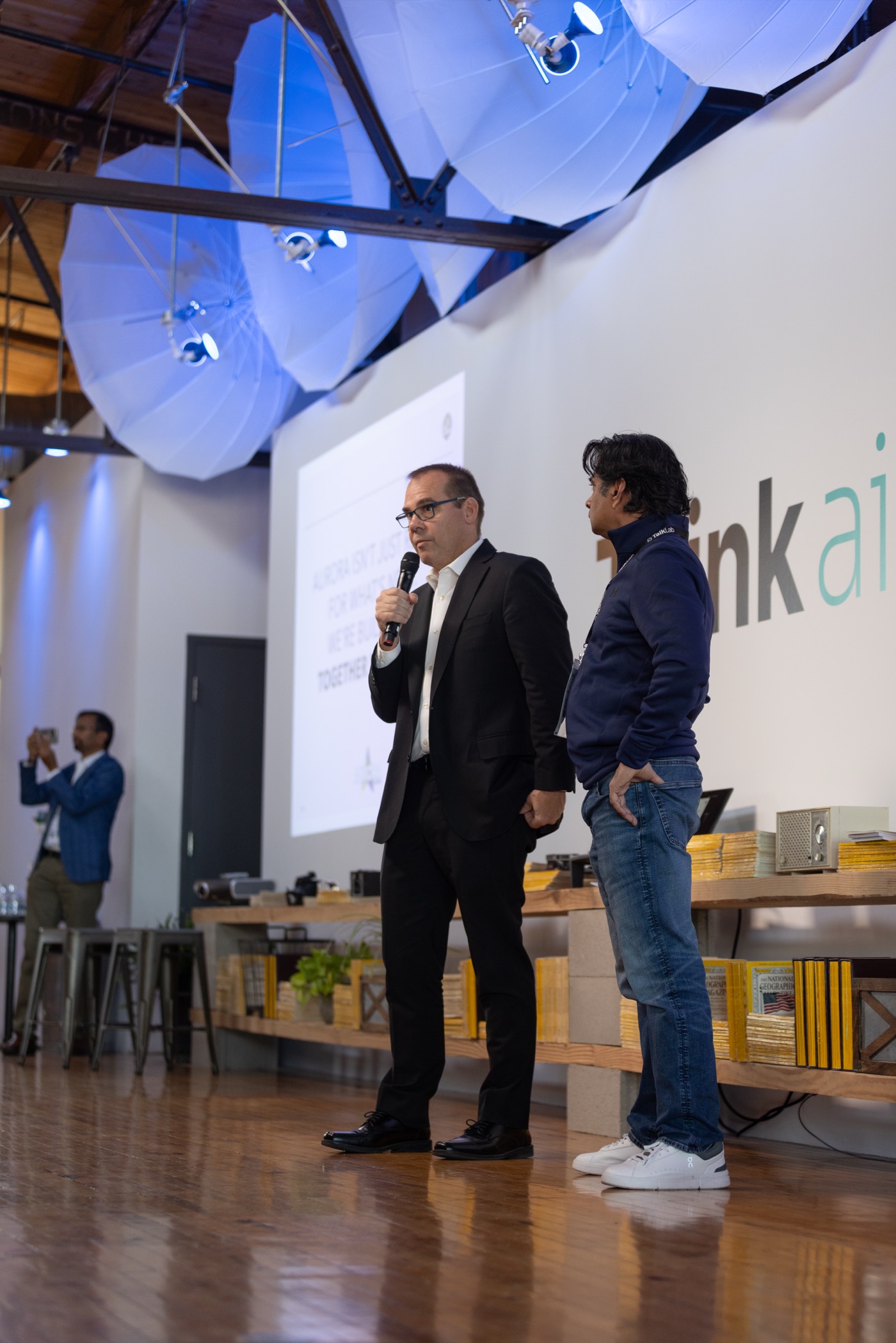 Speakers on stage with partners at a past AI event